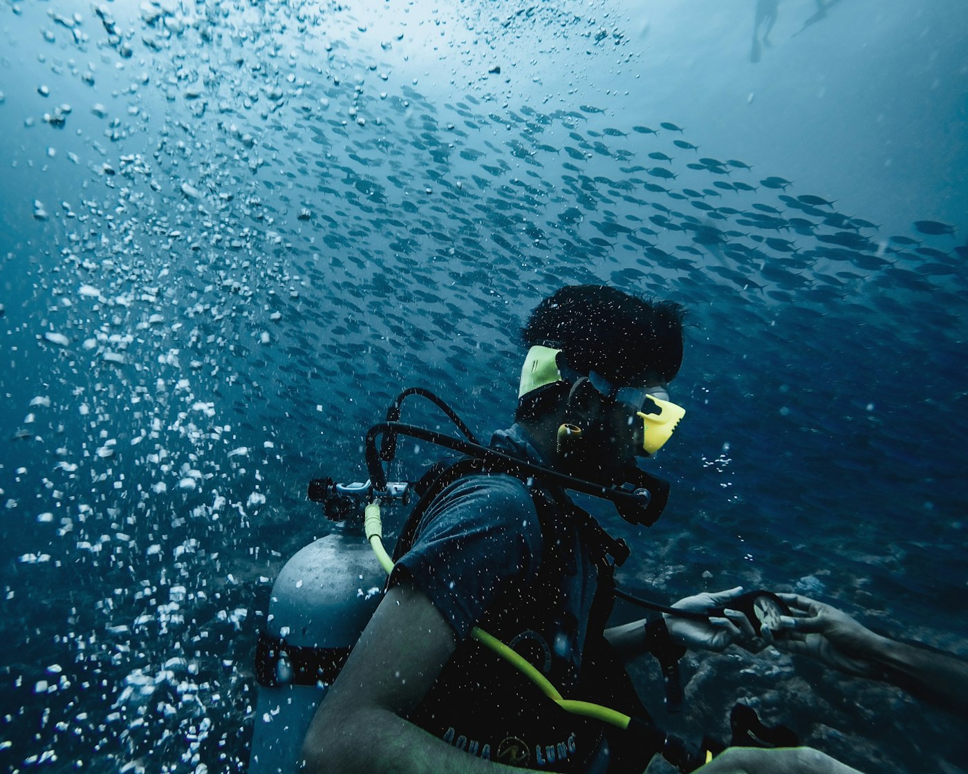 A scuba diver underwater in deep blue water