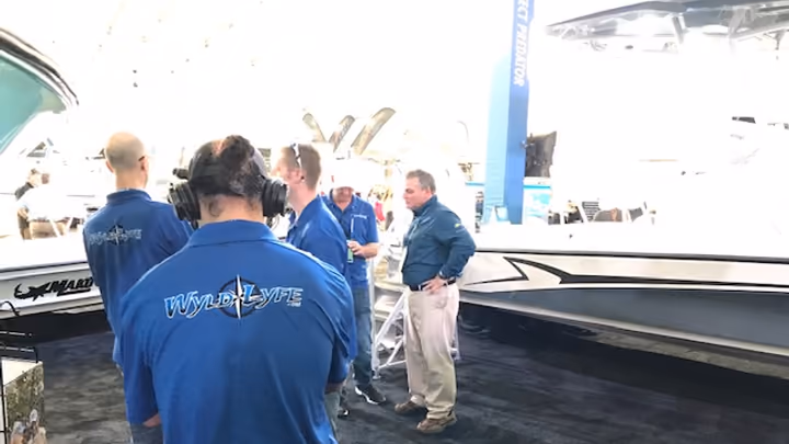The MediaWyld crew filming an interview beside a boat at the show