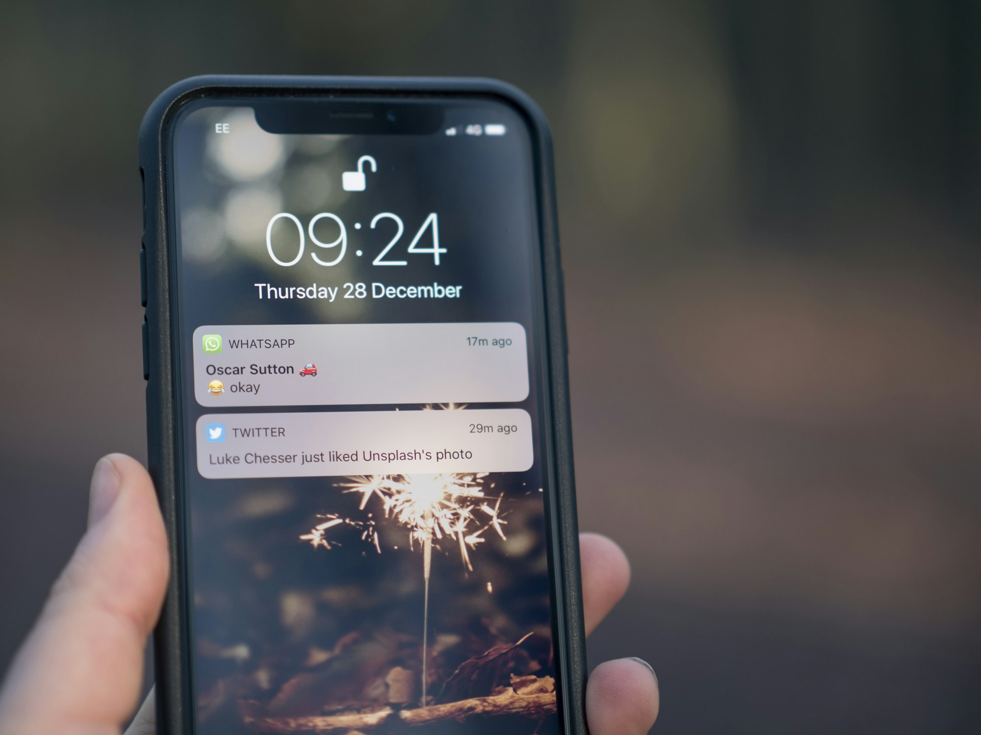 A phone held in hand with a message on the screen