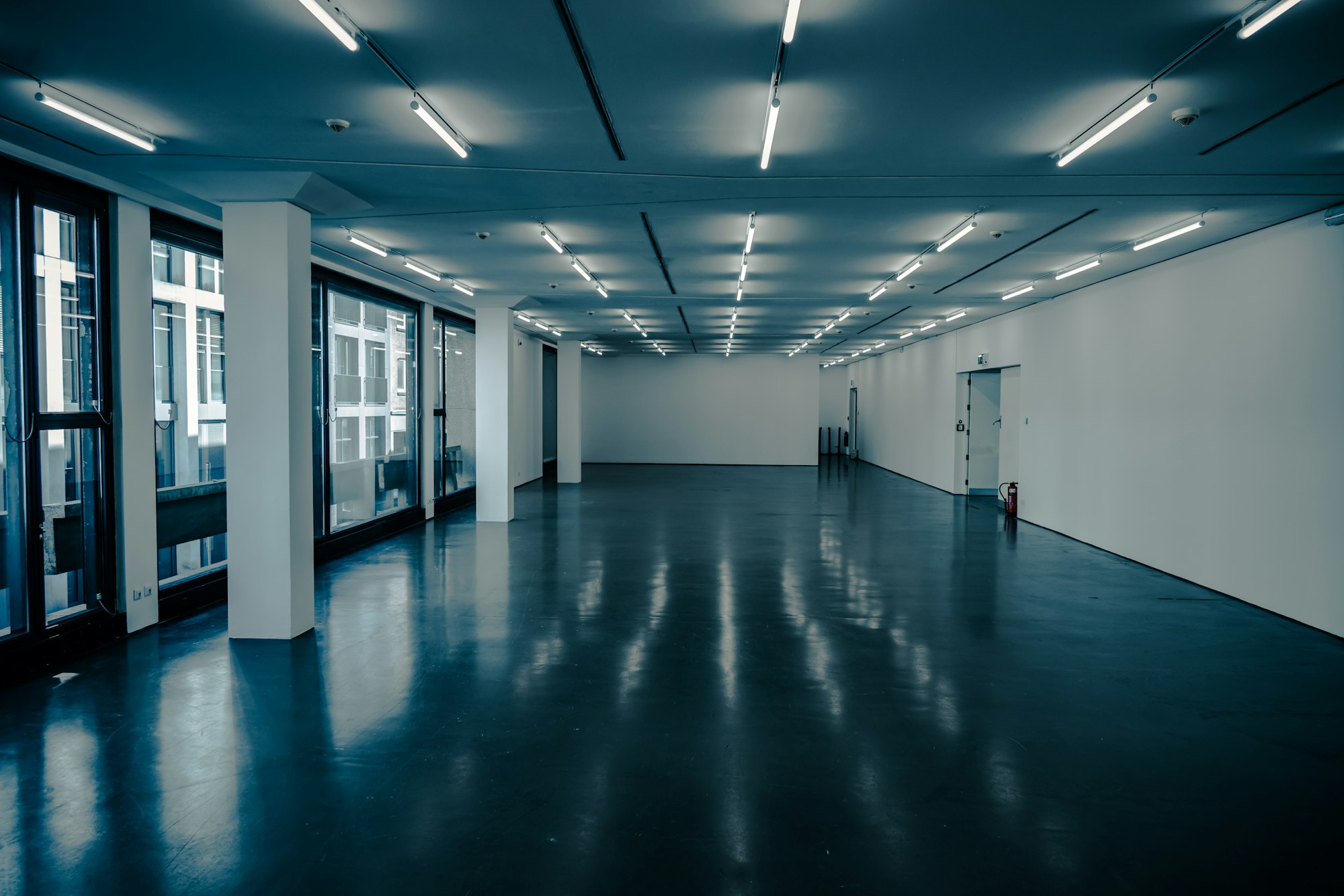 A modern exhibition hall with lit stands